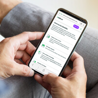 Person browsing on phone the webpage of Billtrust Community