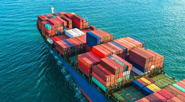 cargo ship in water with many crates onboard