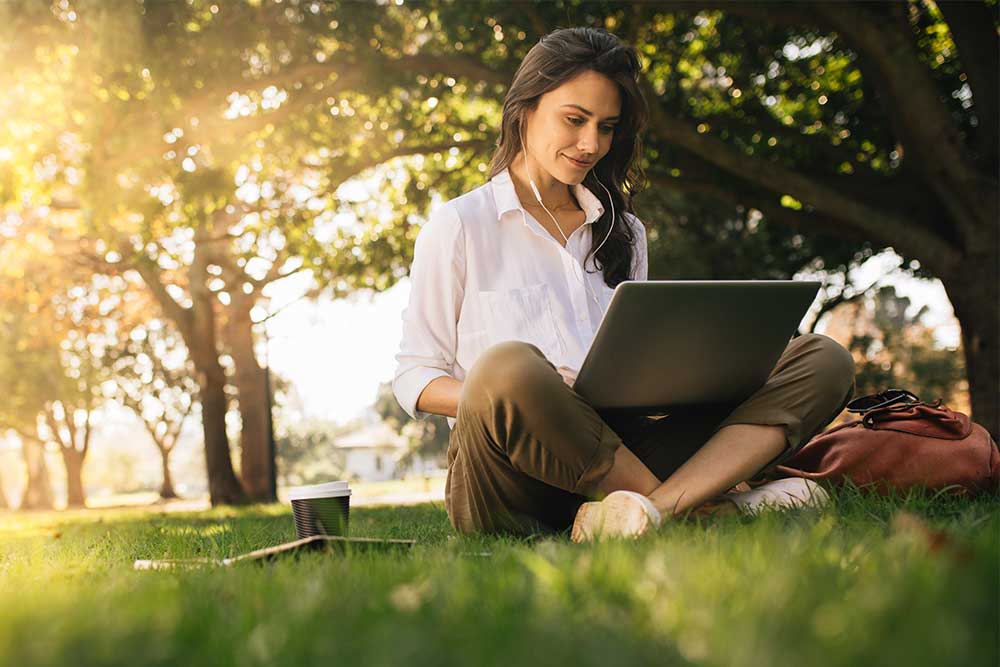 Woman using computer in nature